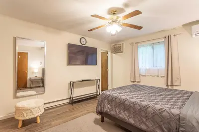 a bedroom with a bed and a ceiling fan at Cozy Poconos Ranch Home with Pool Access, Near Lake! in Gouldsboro