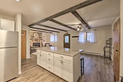 a kitchen with a refrigerator and a counter top at Cozy Poconos Ranch Home with Pool Access, Near Lake! in Gouldsboro