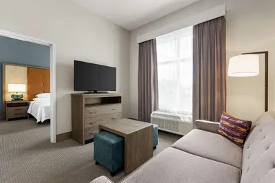 a hotel room with a couch and a television at Homewood Suites By Hilton Carlisle in Carlisle