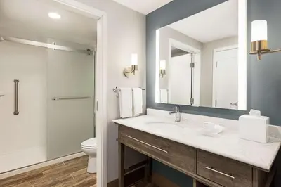 a bathroom with a sink and a toilet and a mirror at Homewood Suites By Hilton Carlisle in Carlisle