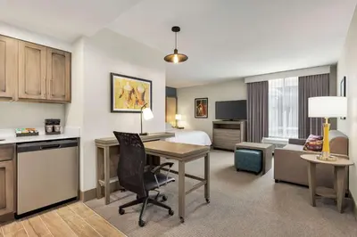 a hotel room with a desk and a bedroom at Homewood Suites By Hilton Carlisle in Carlisle