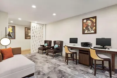 a room with a desk with a computer and chairs at Homewood Suites By Hilton Carlisle in Carlisle