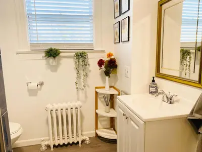 a bathroom with a sink and a toilet and a radiator at Modern Room in Shared Apartment Near NYC in Englewood