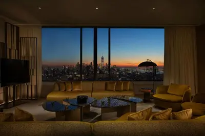 a living room with a view of a city at The Ritz-Carlton New York, NoMad in New York