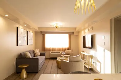 a living room with a couch and a table at The Kenilworth Hotel - Airport West in Kenilworth