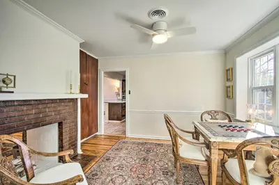 a dining room with a fireplace and a table and chairs at 20 Mi to Philly Inviting Home with Yard in Wayne! in Wayne