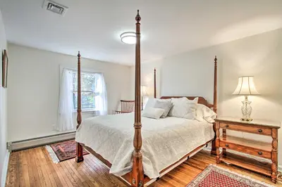 a bedroom with a four poster bed and a window at 20 Mi to Philly Inviting Home with Yard in Wayne! in Wayne