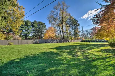 a large yard with trees and a fence at 20 Mi to Philly Inviting Home with Yard in Wayne! in Wayne