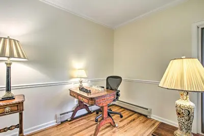 a room with a desk and a chair and a lamp at 20 Mi to Philly Inviting Home with Yard in Wayne! in Wayne