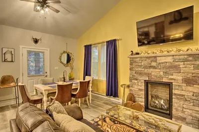 a living room with a couch and a fireplace at 13 Mi to Camelback Ski! Creekside Lincoln Lodge in Brodheadsville