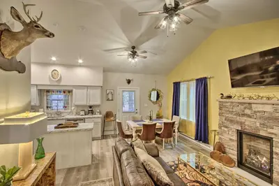 a living room with a couch and a fireplace at 13 Mi to Camelback Ski! Creekside Lincoln Lodge in Brodheadsville