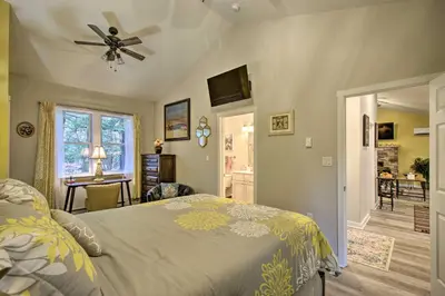 a bedroom with a bed and a ceiling fan at 13 Mi to Camelback Ski! Creekside Lincoln Lodge in Brodheadsville