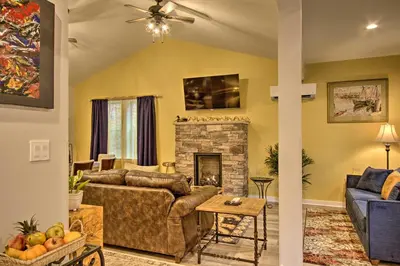 a living room with a couch and a fireplace at 13 Mi to Camelback Ski! Creekside Lincoln Lodge in Brodheadsville