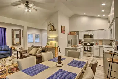 a kitchen and living room with a table and chairs at 13 Mi to Camelback Ski! Creekside Lincoln Lodge in Brodheadsville