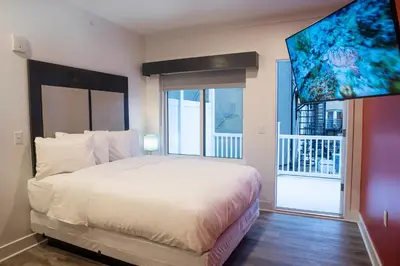 a bedroom with a large bed and a large window at Peachtree Suites - Jersey City in Jersey City