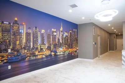 a room with a wall mural of a city skyline at Peachtree Suites - Jersey City in Jersey City