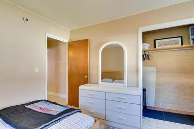 a bedroom with a bed and a dresser with a mirror at Shared Boat Launch Lake Retreat in Ellenville! in Ellenville