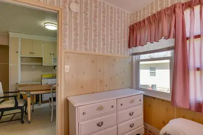a bedroom with a dresser and a table and a window at Shared Boat Launch Lake Retreat in Ellenville! in Ellenville