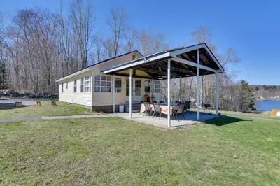 a house with a pavilion with a table in a field at Kayaks and Canoes Lake-View Retreat in Ellenville! in Ellenville