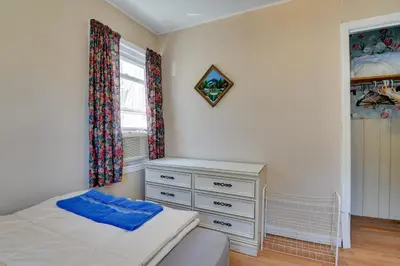 a bedroom with a bed and a dresser and a window at Kayaks and Canoes Lake-View Retreat in Ellenville! in Ellenville