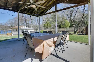 a table and chairs on a patio with a ceiling fan at Kayaks and Canoes Lake-View Retreat in Ellenville! in Ellenville