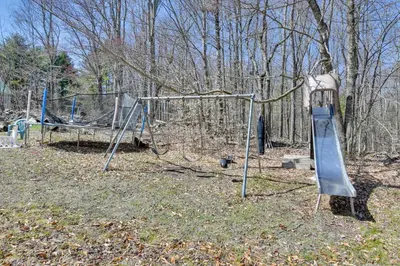 a playground with a slide in a park at Kayaks and Canoes Lake-View Retreat in Ellenville! in Ellenville