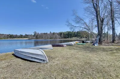 a group of boats sitting on the shore of a lake at Kayaks and Canoes Lake-View Retreat in Ellenville! in Ellenville