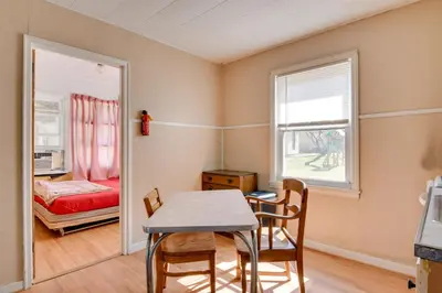 a dining room with a table and chairs and a bedroom at Kayaks and Canoes Lake-View Retreat in Ellenville! in Ellenville