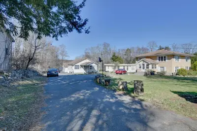 a street in a residential neighborhood with a house at Shared Lake Access and Fire Pit Catskills Getaway! in Ellenville