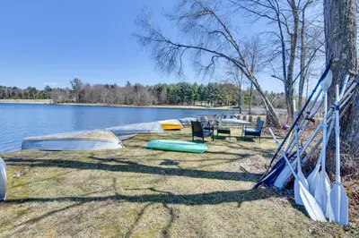 a group of boats sitting on the shore of a lake at Shared Lake Access and Fire Pit Catskills Getaway! in Ellenville