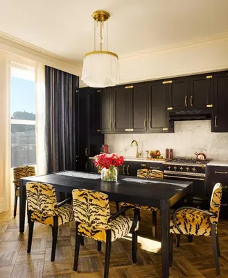 a kitchen with a black table and yellow chairs at The Hotel Chelsea in New York
