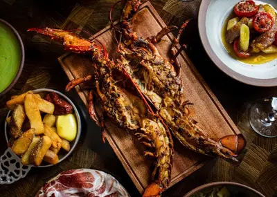 a table topped with seafood and a plate of french fries at The Hotel Chelsea in New York