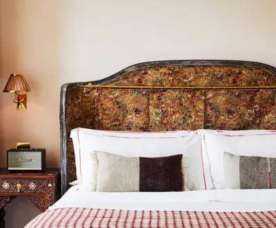 a bedroom with a large bed with a copper headboard at The Hotel Chelsea in New York