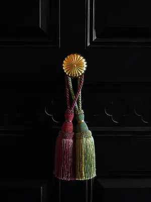 a group of tassles hanging on a wall at The Hotel Chelsea in New York