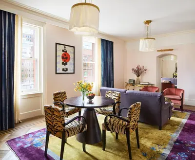 a living room with a table and chairs and a couch at The Hotel Chelsea in New York