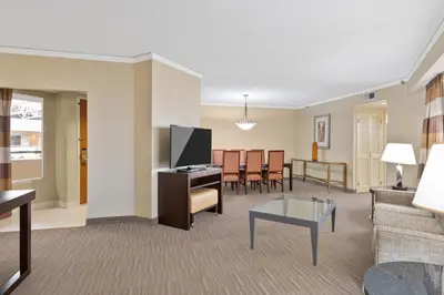 a living room with a flat screen tv and a couch at Harmony Suites Secaucus Meadowlands in Secaucus