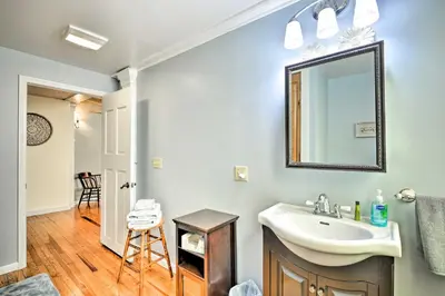 a bathroom with a sink and a mirror at Lisle Apt Fireplace and Stained Glass Windows! in Lisle