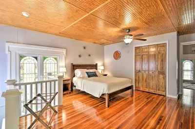 a bedroom with a bed and a wooden ceiling at Lisle Apt Fireplace and Stained Glass Windows! in Lisle