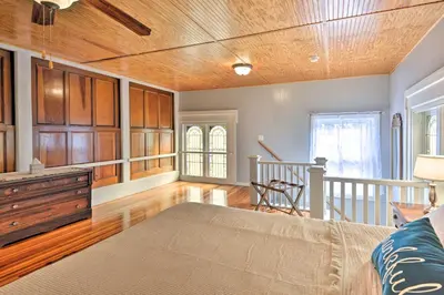 a living room with a couch and a wooden ceiling at Lisle Apt Fireplace and Stained Glass Windows! in Lisle
