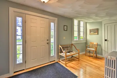 a room with a door and a chair and windows at Lisle Apt Fireplace and Stained Glass Windows! in Lisle