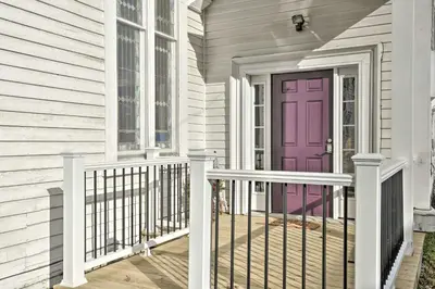 a purple door on a house with a porch at Lisle Apt Fireplace and Stained Glass Windows! in Lisle