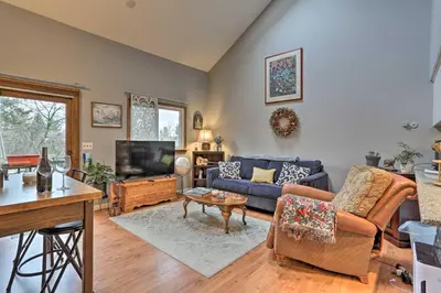 a living room with a couch and a tv at Pet-Friendly Townhome with Community Hot Tub! in Vernon Township