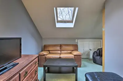 a living room with a couch and a tv at Pet-Friendly Townhome with Community Hot Tub! in Vernon Township