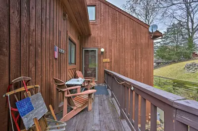 a deck with chairs and a table on the side of a building at Pet-Friendly Townhome with Community Hot Tub! in Vernon Township