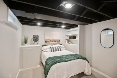 a bedroom with a bed and a black ceiling at 