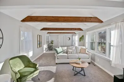 a living room with a white couch and chairs at 