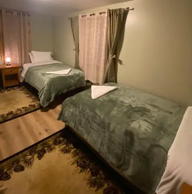 a bedroom with two beds and a window at The Nook Lodge - cabin with hot tub at Shawnee and Camelback Mtn in East Stroudsburg