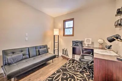 a living room with a couch and a desk at Modern East Stroudsburg Home with Pool and Fire Pit in East Stroudsburg