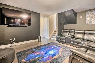 a living room with a leather couch and a rug at Modern East Stroudsburg Home with Pool and Fire Pit in East Stroudsburg