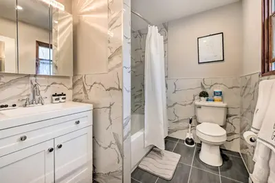 a bathroom with a toilet and a sink at Modern East Stroudsburg Home with Pool and Fire Pit in East Stroudsburg